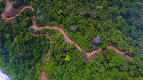 Aerial-video-looking-down-on-a-walking-path-cutting-through-the-mountains-of-Playa-Herradura-in-Costa-Rica