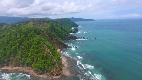 Pull-back-along-the-green-coastline-of-Costa-Rica-near-Playa-Herradura-on-a-cloudy-day-in-the-tropical-jungle-mountains