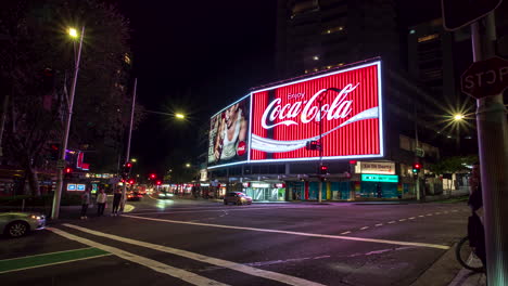 Coca-Cola-logo-in-Sydney,-Australia-at-the-corner-of-Darlinghurst-Road-and-William-Streets---nighttime-time-lapse