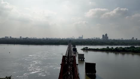Silhouettes-of-Hanoi-cityscape-as-seen-from-Long-Bien-Bridge,-aerial