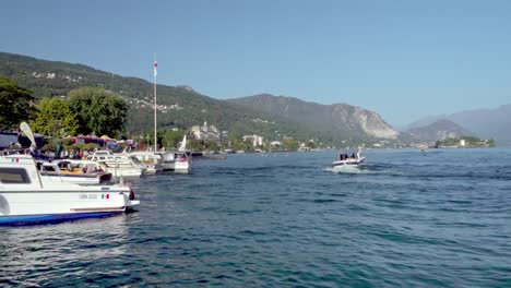 A-sightseeing-boat-leaving-and-another-arriving-at-the-docking-point-on-Lago-Maggiore