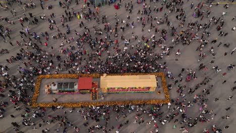 Drone-video-capturing-a-crowd-around-the-Day-of-the-Dead-offering-in-Mexico-City's-historic-center