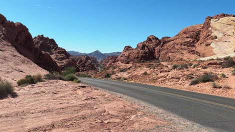 Winding-road-in-the-state-park-Valley-of-Fire-in-Nevada-with-red-hills-around