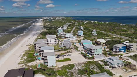 Aerial-clip-of-colorful-condos-and-lush-vegetation-against-sandy-beaches-at-Cape-San-Blas,-Florida
