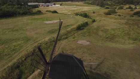 Faddersbol-Molle,-Thisted,-Denmark---A-Vista-of-Lush-Surroundings-Encircling-the-Antique-Windmill---Aerial-Pullback