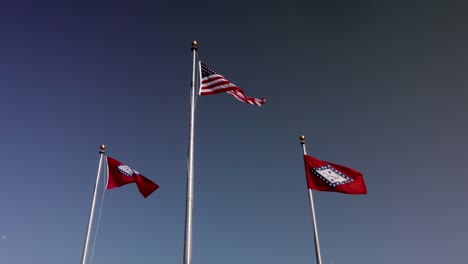 Arkansas-state-flags-and-American-flag-waving-in-the-wind-in-slow-motion