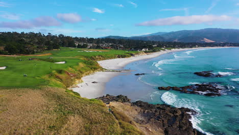 Drone-shot-low-over-the-Pebble-beach,-sunny-day-in-Monterey,-California,-USA