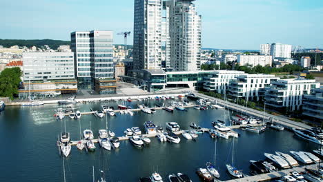 Modern-marina-with-boats,-city-skyline-in-Gdynia-near-Sea-Tower