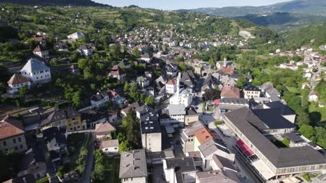 Aerial-view-circling-scenic-forested-Jajce-city-landscape-in-Bosnia-and-Herzegovina-mountain-valley