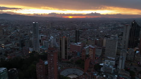 Aerial-view-over-skyscrapers-in-downtown-Bogota,-sunset-in-Colombia