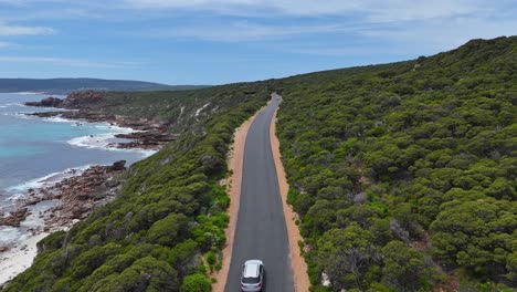 Drone-following-car-along-scenic-coastline-in-Margaret-River,-Western-Australia
