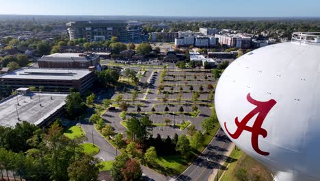 water-tower-with-alabama-football-stadium-in-the-distance-aerial