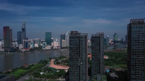 Aerial-Vietnam,-Ho-Chi-Minh-City-iconic-buildings-of-Skyline-on-sunny-clear-day-featuring-architecture,-and-Saigon-River