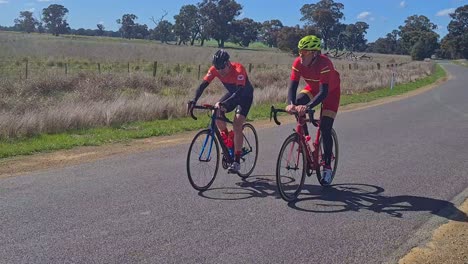 Yarrawonga,-Victoria,-Australia---21-August-2022:-Two-male-cycle-road-race-riders-rounding-a-bend-in-the-country-on-their-way-to-the-finish-in-Yarrawonga