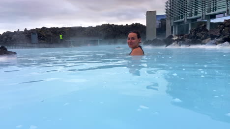 Pretty-young-woman-bathing-and-smiling-in-Icelandic-Blue-Lagoon