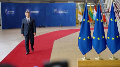Croatian-Prime-Minister-Andrej-Plenković-arriving-on-the-red-carpet-at-the-European-Council-summit-in-Brussels,-Belgium---Slow-motion