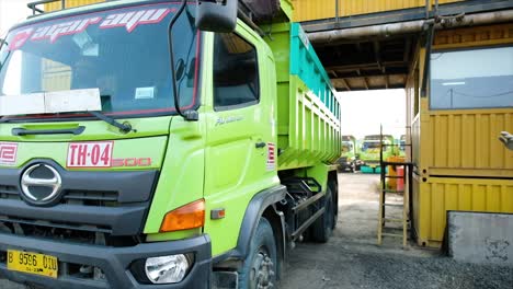 Truck-has-been-filled-with-mixed-and-homogeneous-aggregate-into-the-transport-truck-by-opening-the-opening-door-at-the-bottom-of-the-mixer-with-hydraulic-control-at-the-Asphalt-Mixing-Plant-factory