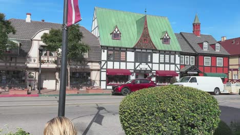 Walking-on-the-street-in-Solvang,-California,-very-danish-looking-town-with-people-eating,-crossing-street-etc