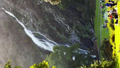 Sunny-Riverside-Retreat:-Families-and-Friends-Enjoying-Barbecue-Bliss-with-Powerscourt-Waterfall-Backdrop-in-Wicklow,-Ireland