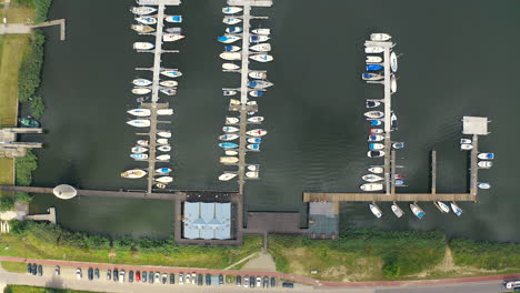high-top-view-aerial-shot-of-marina-and-yachts-in-Blotnik,-Pomeranian,-Poland