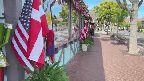 Colourful-street-shops-with-flags-in-Solvang-danish-looking-town-in-California