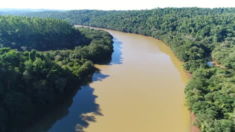 Beautiful-river-with-brown-waters-flowing-through-the-heart-of-the-Amazon-rainforest