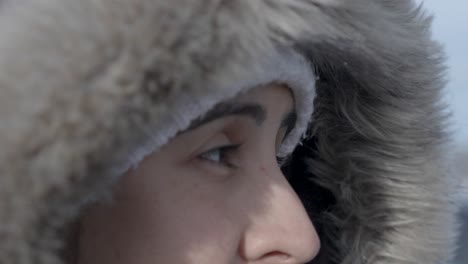 Close-up-of-woman-in-fur-hood-in-Iceland,-chill-in-a-wanderer's-eyes