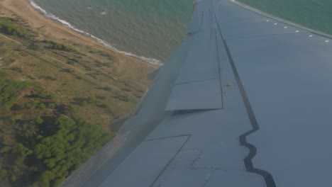 Airplane-flying-over-the-sea-wing-view
