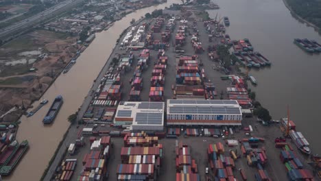 Hyperlapse-over-Saigon-River-container-port-in-Ho-Chi-Minh-City,-Vietnam-with-interesting-activity-of-moving-vehicles,-boats,-and-cranes