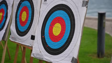 Archery-bullseye-targets-with-markers-at-a-bow-and-arrow-range-near-the-lake,-Close-up-shot