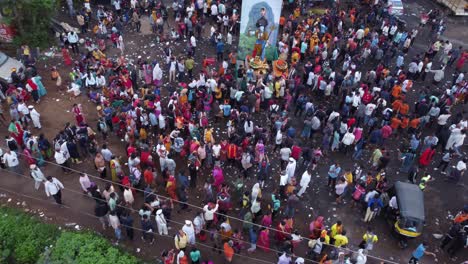 Aerial-view-of-the-crowd-of-Hindu-devotees-and-pilgrims-approaching-a-junction-while-taking-on-foot-journey-around-the-spiritual-mountain-of-Brahmgiri-in-Trimbakeshwar-during-shravana
