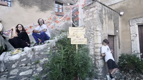 People-at-grape-harvest-festival-of-medieval-Penna-in-Teverina-town-with-decorated-houses-and-streets,-Italy