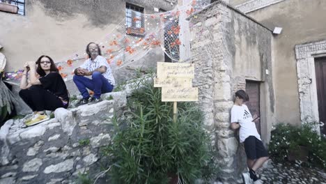 Gente-En-La-Fiesta-De-La-Vendimia-De-La-Penna-Medieval-En-La-Ciudad-De-Teverina-Con-Casas-Y-Calles-Decoradas,-Italia