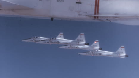 1960s-US-Fighter-Jets-in-Tight-Formation-in-Blu-Sky---Pilot-Cockpit-POV