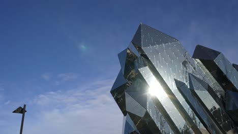 Detail-of-dark-glass-building-in-the-form-of-a-crystal-at-Futuroscope-theme-park-housing-the-largest-IMAX-Laser-Screen-in-Europe,-Zoom-in-shot