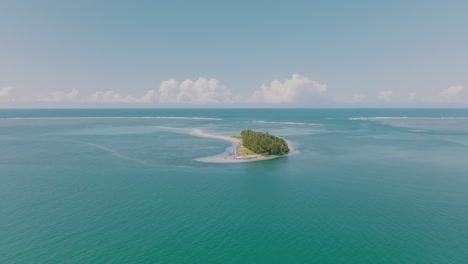 Aerial-shot---Discover-of-tiny-island-with-forest-and-no-people-in-the-middle-of-the-ocean