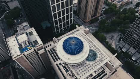 Aerial-tilt-up-shot-showing-rooftops-of-high-rise-buildings-in-Atlanta-Downtown-during-cloudy-day