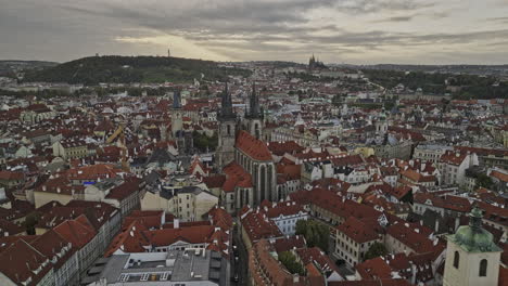 Prague-Czechia-Aerial-v108-low-flyby-Old-town-square-capturing-gothic-cathedral,-Astronomical-Clock,-historical-cityscape-and-hilltop-castle-in-the-background---Shot-with-Mavic-3-Cine---November-2022