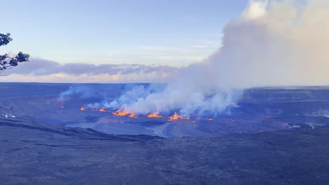 Cinematic-wide-panning-shot-of-the-Kilauea-Volcano-lava-lake-visible-at-sunset-during-the-first-day-of-eruption-in-September-2023-on-the-Big-Island-of-Hawai'i