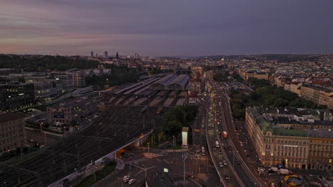 Prague-Czechia-Aerial-v75-low-flyover-Zizkov-across-Vinohrady-capturing-cityscape-of-New-and-Old-Town-and-busy-vehicle-traffics-on-Wilsonova-at-dawn-sunrise---Shot-with-Mavic-3-Cine---November-2022