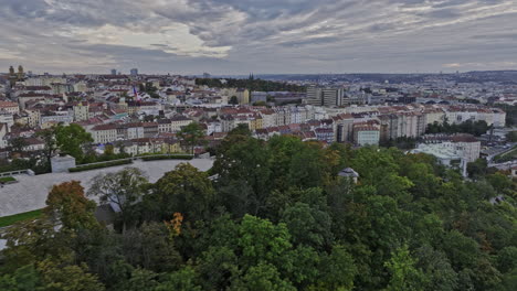 Prague-Czechia-Aerial-v87-fly-around-Vitkov-hill-park,-capturing-hilltop-national-memorial-on-stone-platform-ringed-by-woods-surrounded-by-panoramic-cityscape---Shot-with-Mavic-3-Cine---November-2022