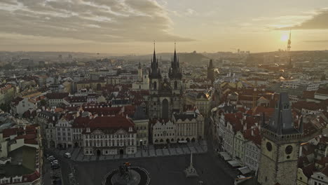 Prague-Czechia-Aerial-v133-flyover-Old-town-square,-dramatic-fly-in-between-gothic-spires-of-Church-of-Our-Lady-before-Tyn-capturing-golden-sunrise-cityscape---Shot-with-Mavic-3-Cine---November-2022