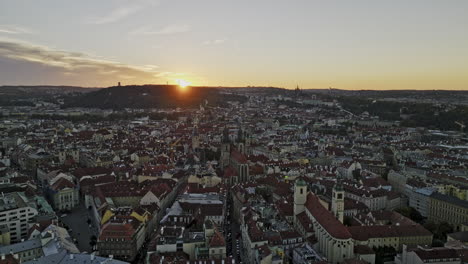Prague-Czechia-Aerial-v64-drone-flyover-Old-Town-capturing-cityscape-of-historical-districts,-narrow-streets-and-Vltava-river-with-sunset-on-the-horizon---Shot-with-Mavic-3-Cine---November-2022