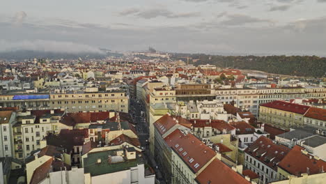 Prague-Czechia-Aerial-v135-low-flyover-Old-town-district-capturing-narrow-streets,-cityscape-with-historical-architectural-buildings-at-sunrise-with-clouds---Shot-with-Mavic-3-Cine---November-2022
