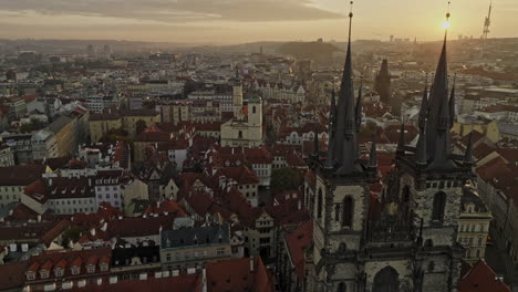 Prague-Czechia-Aerial-v128-drone-flying-past-beside-Church-of-Our-Lady-before-Tyn-at-Old-town-square-towards-city-gate-capturing-New-town-cityscape-at-sunrise---Shot-with-Mavic-3-Cine---November-2022