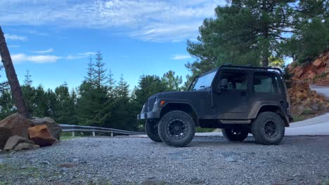 Cool-Jeep-4x4-car-with-beautiful-nature-and-forest-view-around-on-a-mountain,-fun-ATV-adventures-on-a-sunny-day-in-Marbella-Malaga-Spain,-4K-shot