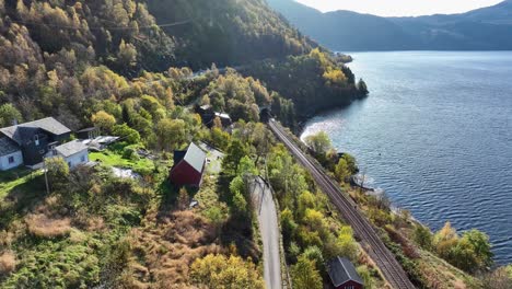 Bergensbanen-railway-at-Skreien-in-beautiful-autumn-sun,-Aerial-Norway