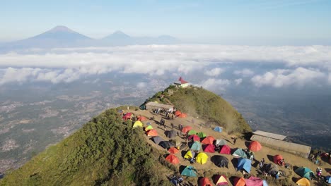 Aerial-view-of-dusty-Andong-mountain-peak-and-people-camping-at-the-top