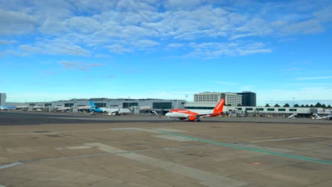 Easyjet-airplane-taking-off-at-international-airport-in-Malaga-Spain,-flying-on-holiday-vacation,-sunny-weather-and-blue-sky,-4K-shot