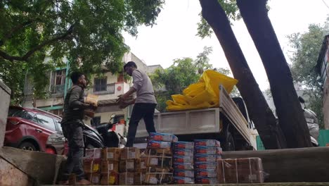 Workers-are-loading-cardboard-boxes-into-a-pickup-truck